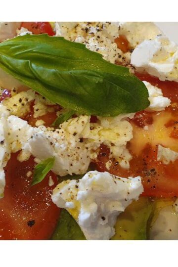 plate of freshly made tomato avocado with feta